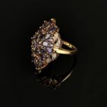 Gold ring, 375/9K yellow gold (hallmarked), total weight 5.36g, flower-shaped front side with purpl