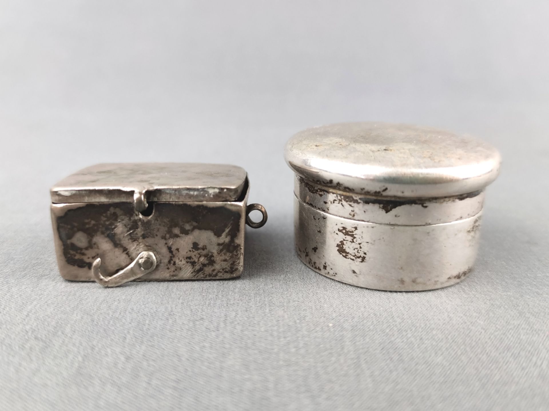 Kleine Deckeldosen, eine punziert Silber 800 (23,9g), mit goldener Innenseite, die andere eckig mit