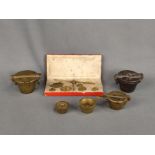 Three beaker weights and a fine scale (one part missing) in a case, 19th century, height of largest