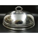 A Large silver plated cloche with decoration all round and family crest. Size 19" x 14"