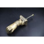 French Brass door knocker in the shape of a fist holding a ball