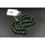 Green Jade necklace with 9ct gold clasp (knotted either side of beads)