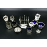 A collection of silver items, including toast rack, silver mustard/salts. Weight "without liners"