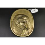Japanese brass plaque in relief of a female face in a head scarf