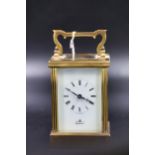 An Imperial brass carriage clock, with white enamel dial and roman numerals. Back plate marked