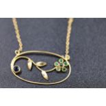 An 18ct gold necklace with a flower pendant with small semi precious stones - 2.9 grams