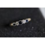 A 5 stone diamond and sapphire ring