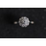 0 25 diamond solitaire ring set in a diamond cluster in 18ct yellow gold