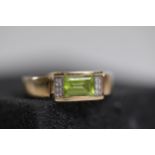 Emerald Cut peridot with diamond shoulders in 9ct yellow gold