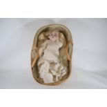 Bisque Doll in straw wicker baby basket