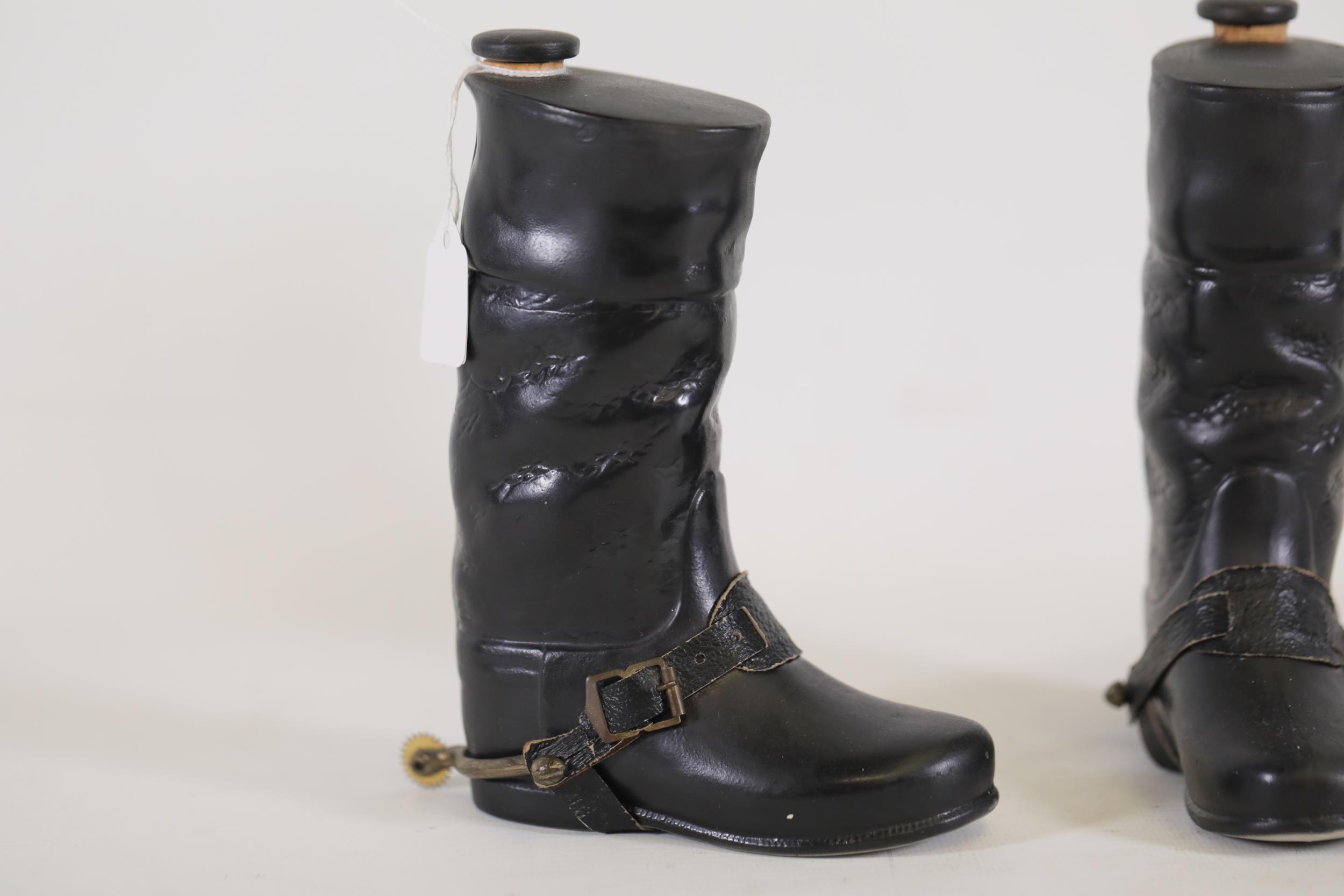 A Pair of ceramic hip flasks in the shape of riding boots