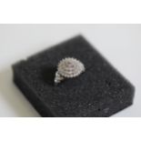 A diamond cluster ring set in 9ct white gold