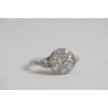 A diamond cluster ring with diamond shoulders set in Platinum