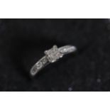 0 75 diamond solitaire claw set ring diamond shoulders 4 small diamonds set in square formation