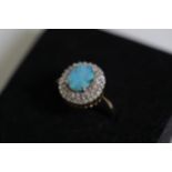 A Oval Opal and diamond cluster ring set in 9ct yellow gold