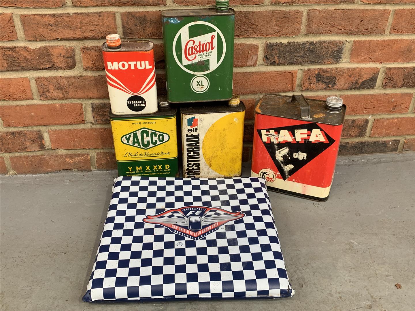 Five Vintage French Oil Cans & 2001 US Grand Prix Cushion