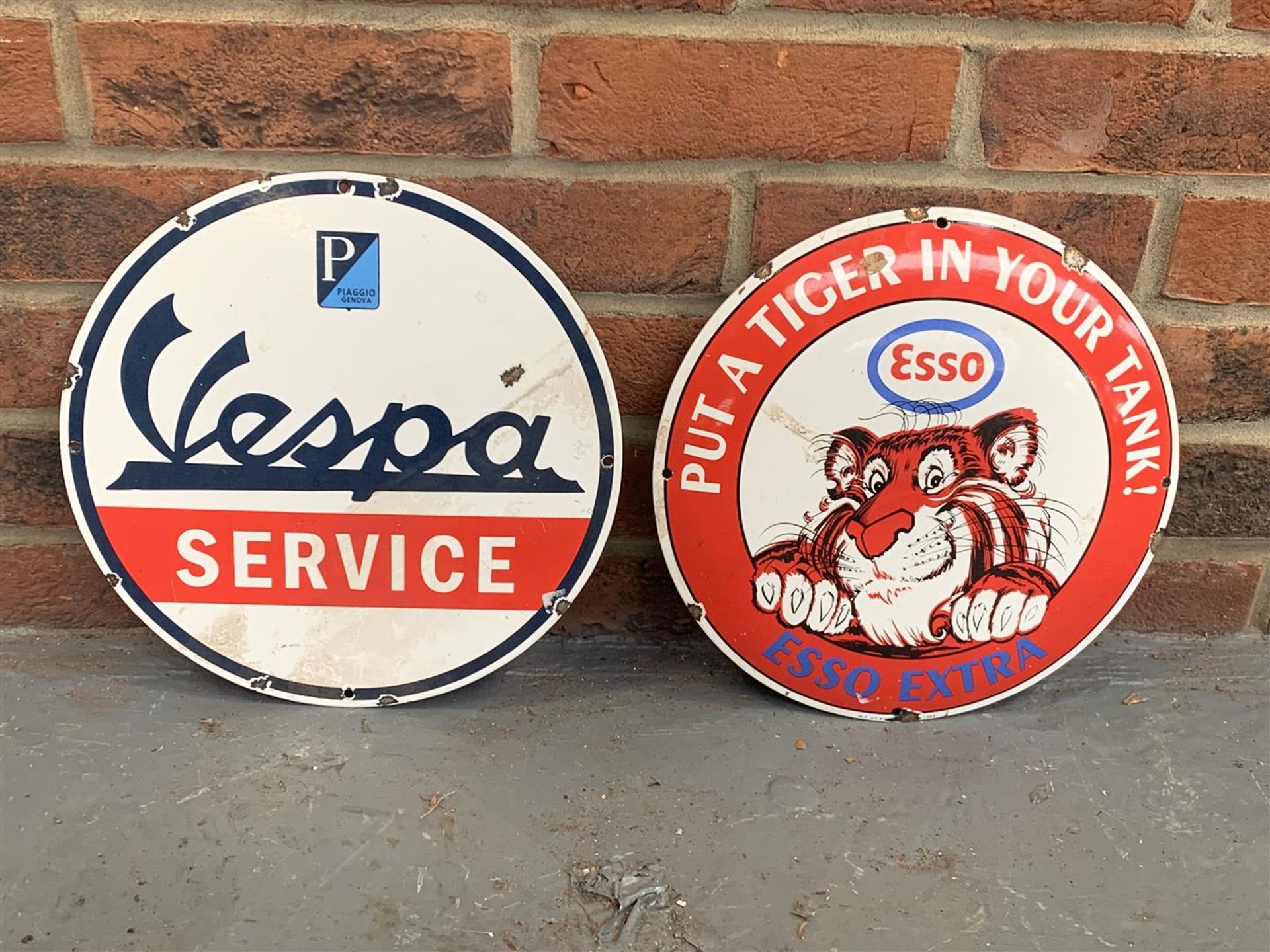 Two Circular Enamel Vespa Service & Esso Extra Signs