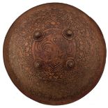 A RARE 17TH CENTURY MUGHAL INDIAN CARVED AND POLYCHROMED HIDE SHIELD OR DHAL, with four ornate