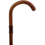A 19TH CENTURY PRISON WARDER'S WALKING CANE, malacca crook handle with leather bound collar, and