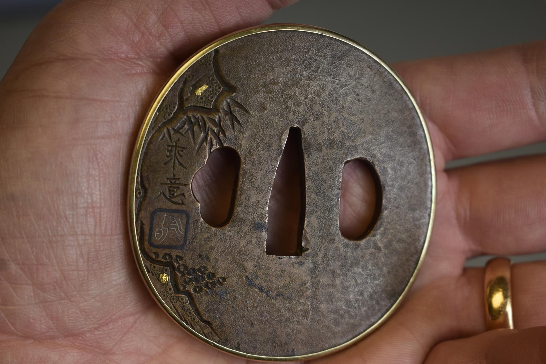A CIRCULAR COPPER TSUBA, decorated with a figure in a cave within a landscape, gold and shakudo - Image 4 of 5