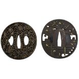 TWO CIRCULAR IRON TSUBA, the first pierced and chiselled with a fence, soft metal details, signed