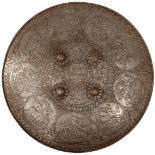 A LATE 19TH/EARLY 20TH CENTURY CHISELLED STEEL INDIAN DHAL OR SHIELD, 54.5cm diameter with turned