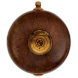 A 17TH CENTURY GERMAN OR SCANDINAVIAN POWDER FLASK, the flattened circular fruitwood body inset to