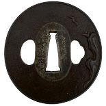 A CIRCULAR IRON TSUBA, decorated with a bird in flight over a rocky landscape, signed Toshitsugu