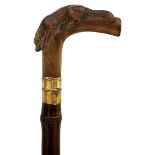 A CONTINENTAL SWORD STICK, the horn handle carved as a resting hound, 34cm flattened diamond section