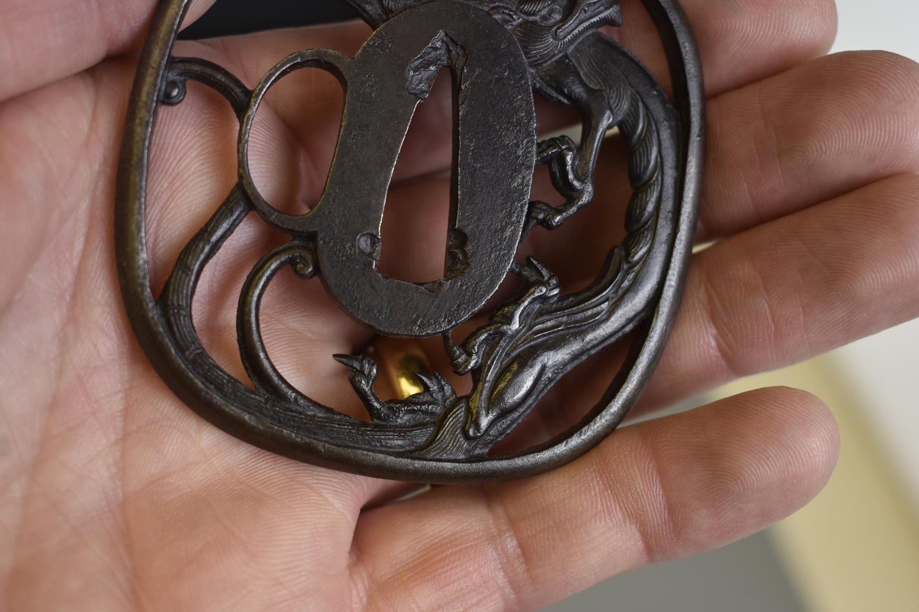 AN IRON SUKASHI TSUBA, chiselled and pierced with a dragon, in wood box, 7.4cm. - Image 5 of 6