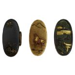 THREE PAIRS OF FUCHI-KASHIRA, the first of shakudo decorated with a tori and presents in the rain,