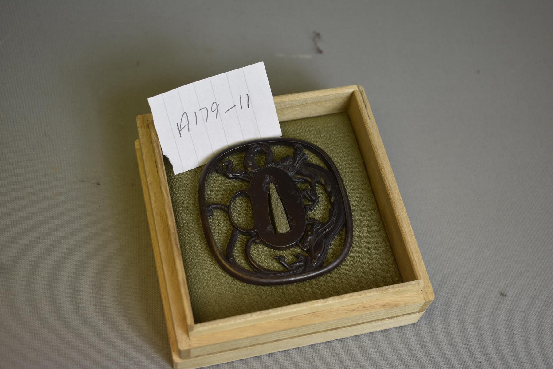 AN IRON SUKASHI TSUBA, chiselled and pierced with a dragon, in wood box, 7.4cm. - Image 2 of 6