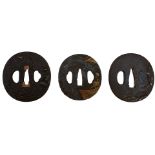 THREE CIRCULAR IRON TSUBA, the first chiselled with a landscape, soft metal details, the second with