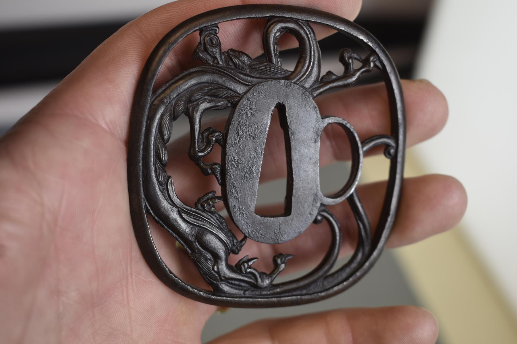 AN IRON SUKASHI TSUBA, chiselled and pierced with a dragon, in wood box, 7.4cm. - Image 6 of 6