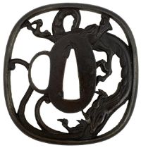 AN IRON SUKASHI TSUBA, chiselled and pierced with a dragon, in wood box, 7.4cm.