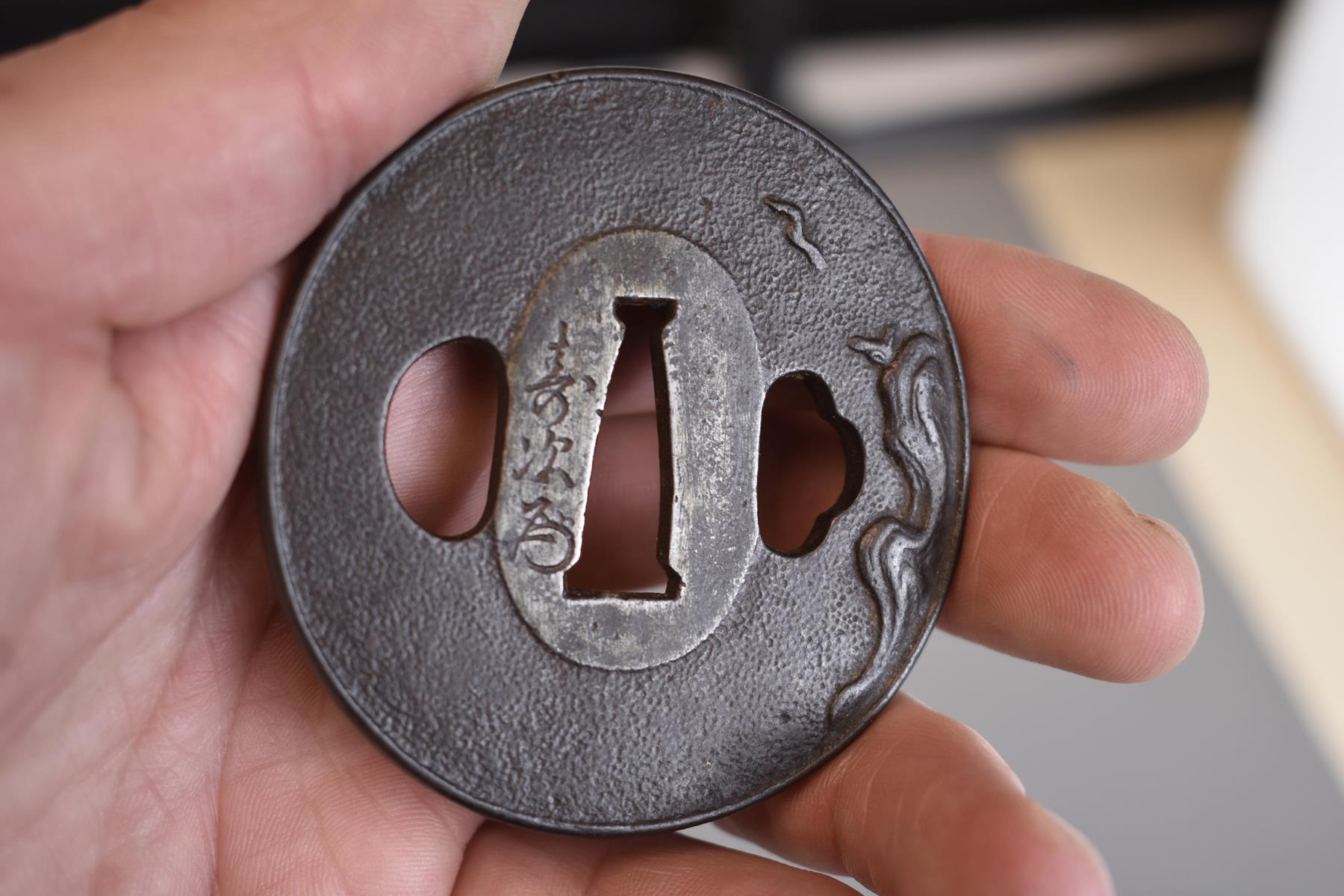 A CIRCULAR IRON TSUBA, decorated with a bird in flight over a rocky landscape, signed Toshitsugu - Image 3 of 5