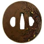 A CIRCULAR COPPER TSUBA, decorated with a figure in a cave within a landscape, gold and shakudo