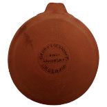 A SCARCE 19TH CENTURY LIGOWSKY CLAY PIGEON, the red clay ribbed body embossed GEORGE EGESTORFF
