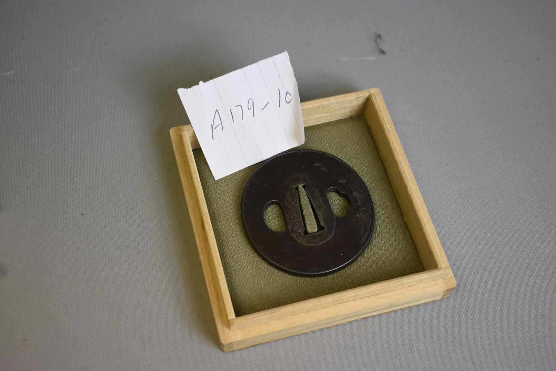 A CIRCULAR IRON TSUBA, decorated with a bird in flight over a rocky landscape, signed Toshitsugu - Image 2 of 5