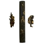 A KODZUKA AND TWO PAIRS OF MENUKI, the first of shibuichi decorated with a dragon amidst crashing