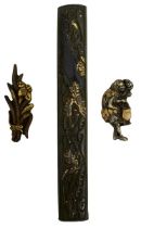 A KODZUKA AND TWO PAIRS OF MENUKI, the first of shibuichi decorated with a dragon amidst crashing
