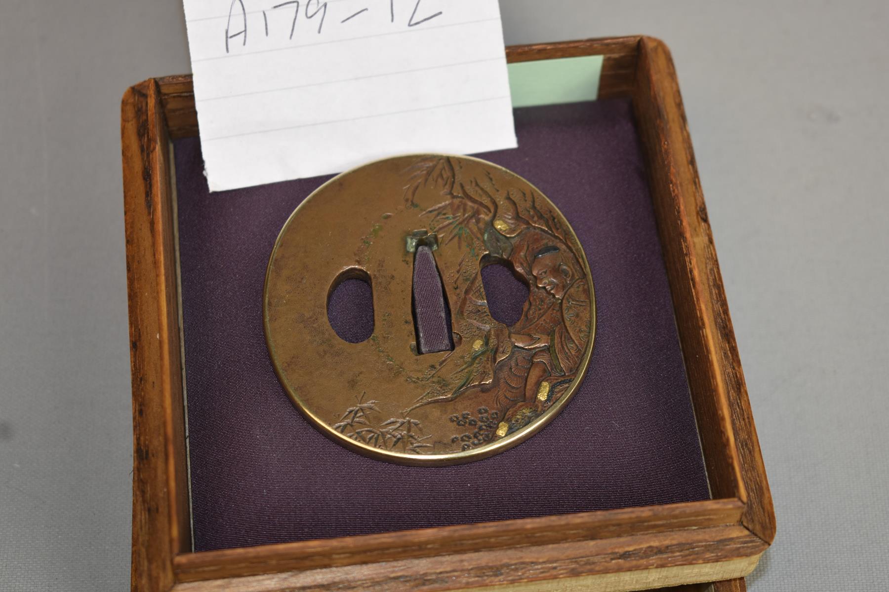 A CIRCULAR COPPER TSUBA, decorated with a figure in a cave within a landscape, gold and shakudo - Image 2 of 5