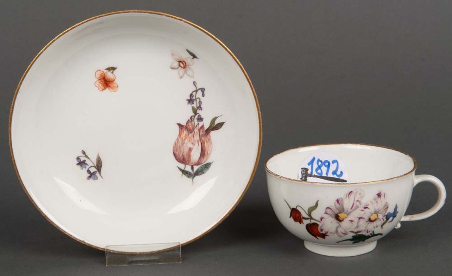 Tasse mit Unterschale. Meissen 1750. Porzellan, bunt floral bemalt, mit Goldrand. Am Boden