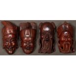 Vier Masken. Asien. Massivholz, geschnitzt, H=35 bis 40 cm, B=18 bis 22 cm.