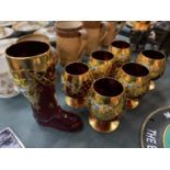 SIX GILDED DECORATIVE RED GLASSES AND A MATCHING BOOT