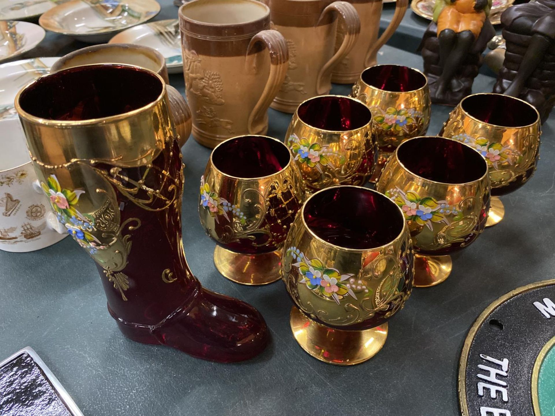SIX GILDED DECORATIVE RED GLASSES AND A MATCHING BOOT