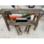 A SMALL VINTAGE WORK BENCH WITH TWO BENCH VICES