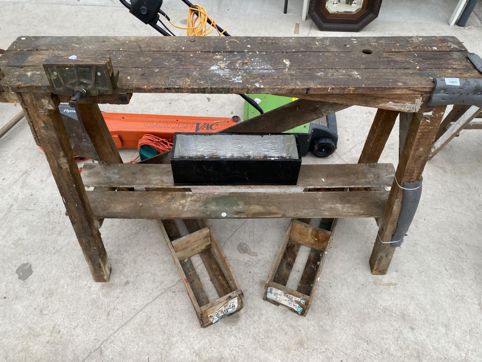 A SMALL VINTAGE WORK BENCH WITH TWO BENCH VICES