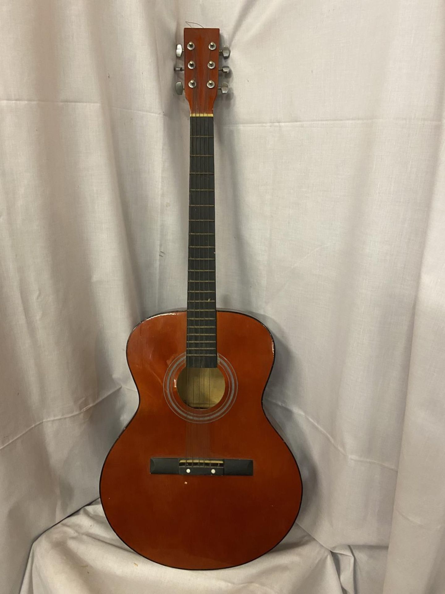 AN ACCOUSTIC GUITAR. (ONLY 5 STRINGS)