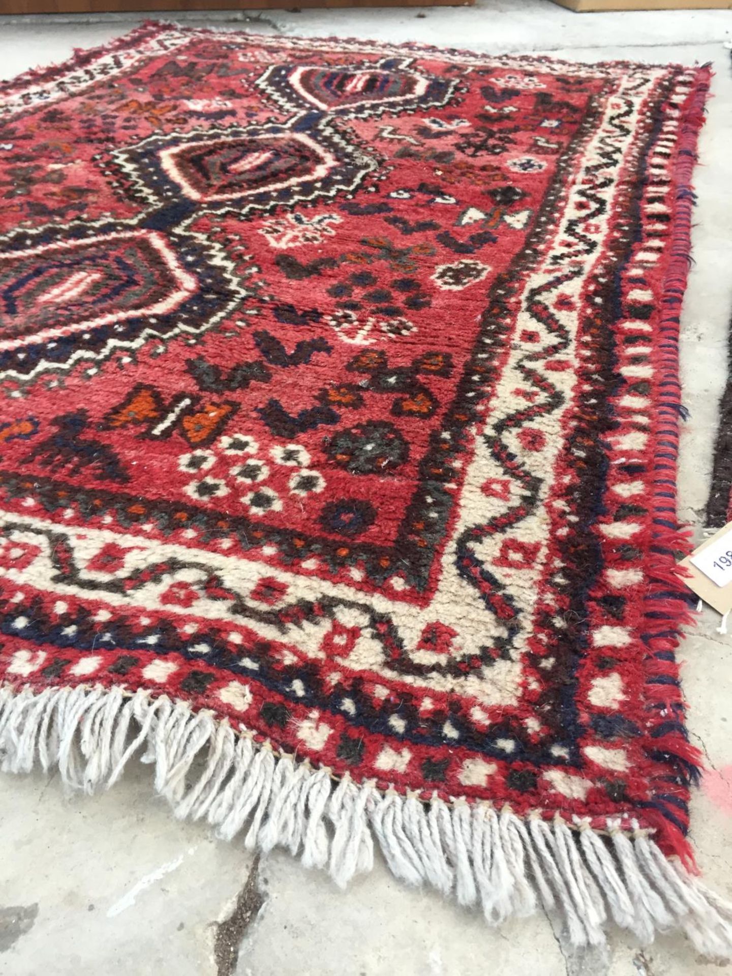 A RED GROUND RUG, 58" X 40" - Image 2 of 3